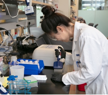 a person in a lab coat working in a laboratory