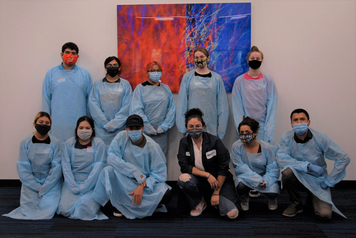The eight Pasadena Unified School District high school students enrolled in HMRI's inaugural Biomedical Research High School STEM program, along with their STEM instructor, teaching assistants and HMRI's Education Program Manager are suited up for dissection day. Front row, left to right: Haydee Angeles, Elizabeth Alvarez, Isaiah Gilmore, Jacqueline Fonseca (STEM Instructor) Ciannah Correa (Teaching Assistant) and Dr. Carlos Aguirre (HMRI Education Program Manager). Back row, left to right: Anthony Romero, Emily Martinez, Arleth Angeles, Amina Malone and Skylar Adams.